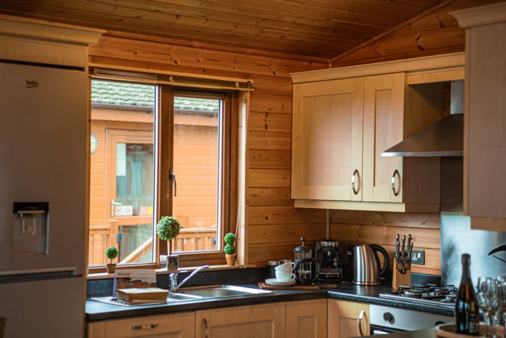 Oakcliff's Pine Lodge kitchen with a large window letting in natural light.