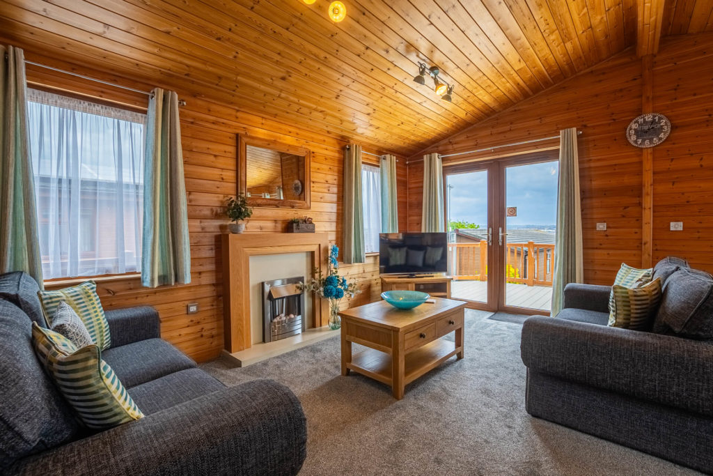 Oakcliff's Pine Lodge living room. Including beautiful wooden walls and furniture
