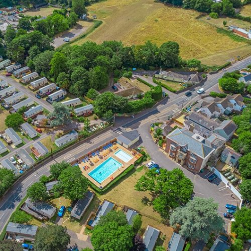 Birds-eye view of Oakcliff Holiday Park. Lodges, caravans and cottages with an outdoor swimming pool