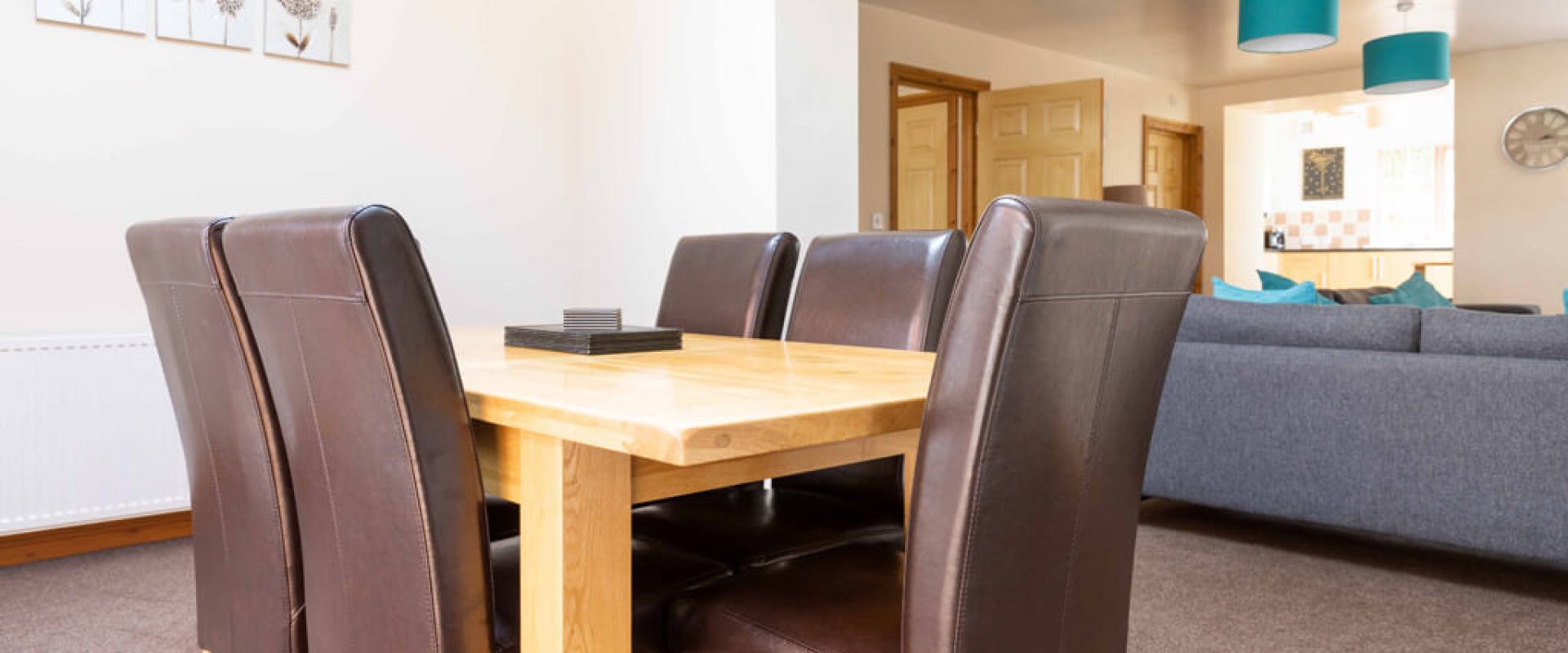 Oakcliff's Mews Cottage dining table. Consisting of a woden table and 6 brown, leather chairs.