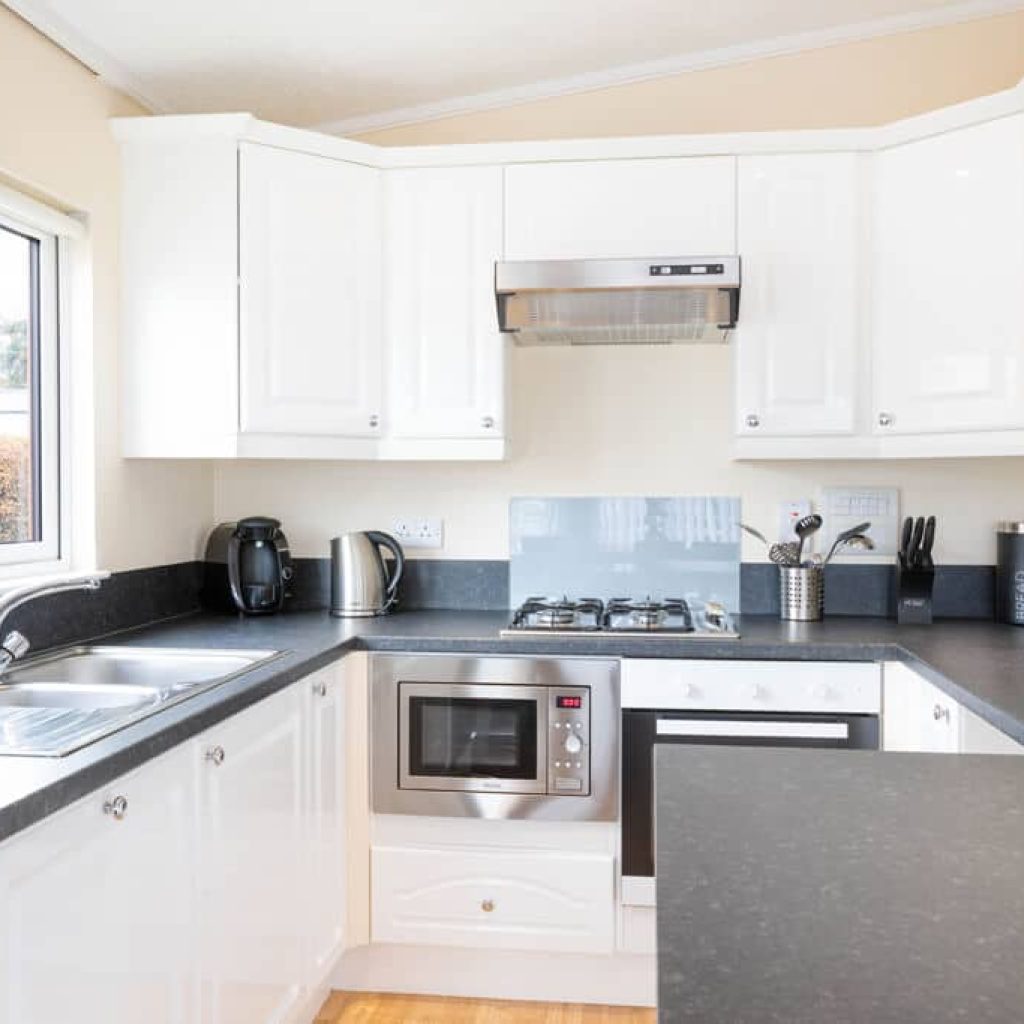 Oakcliff's Oak Lodge grey and white kitchen with a peninsula.