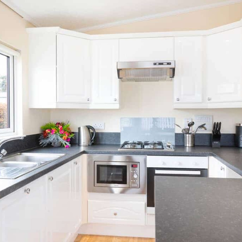 Oakcliff's Oak Lodge grey and white kitchen with a peninsula.