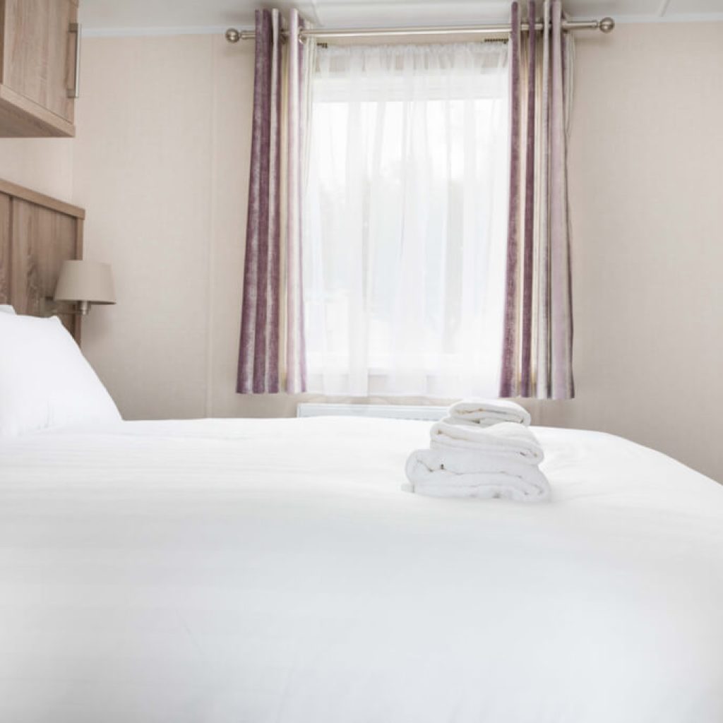 Oakcliff's Osprey Premier Mini Lodge double bedroom. Including a built-in wardrobe