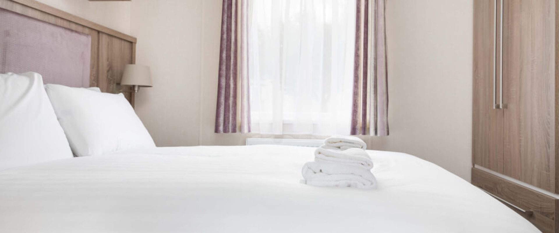 Oakcliff's Osprey Premier Mini Lodge double bedroom. Including a built-in wardrobe