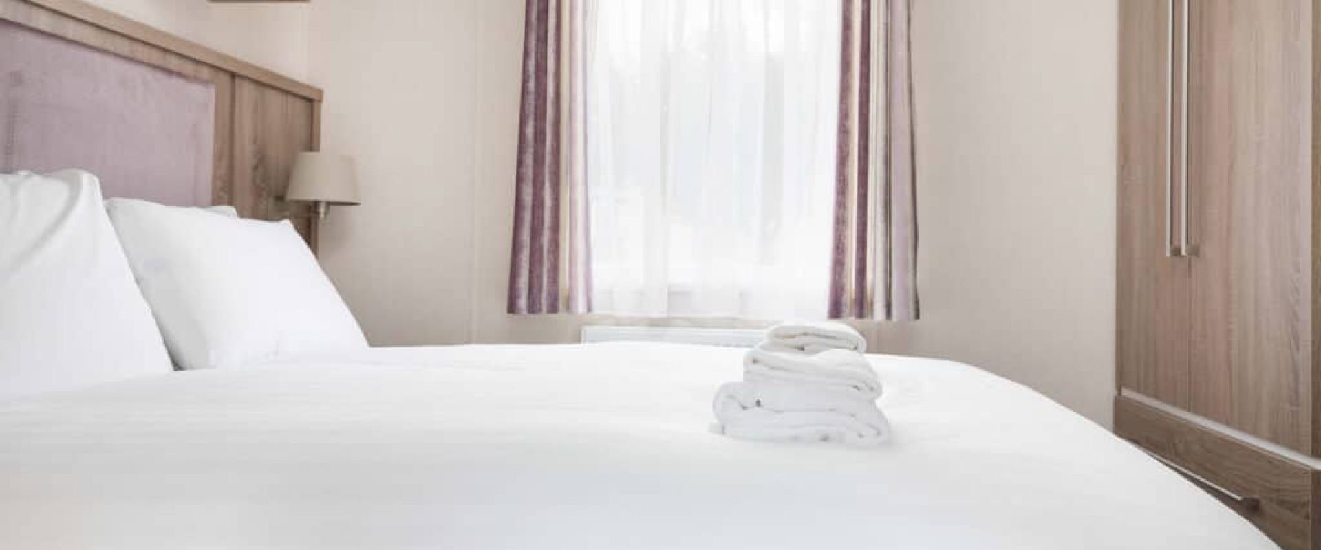 Oakcliff's Osprey Premier Mini Lodge double bedroom. Including a built-in wardrobe