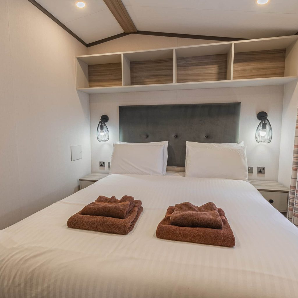 Oakcliff's Lapwing Mini Lodge double bedroom with overhead storage