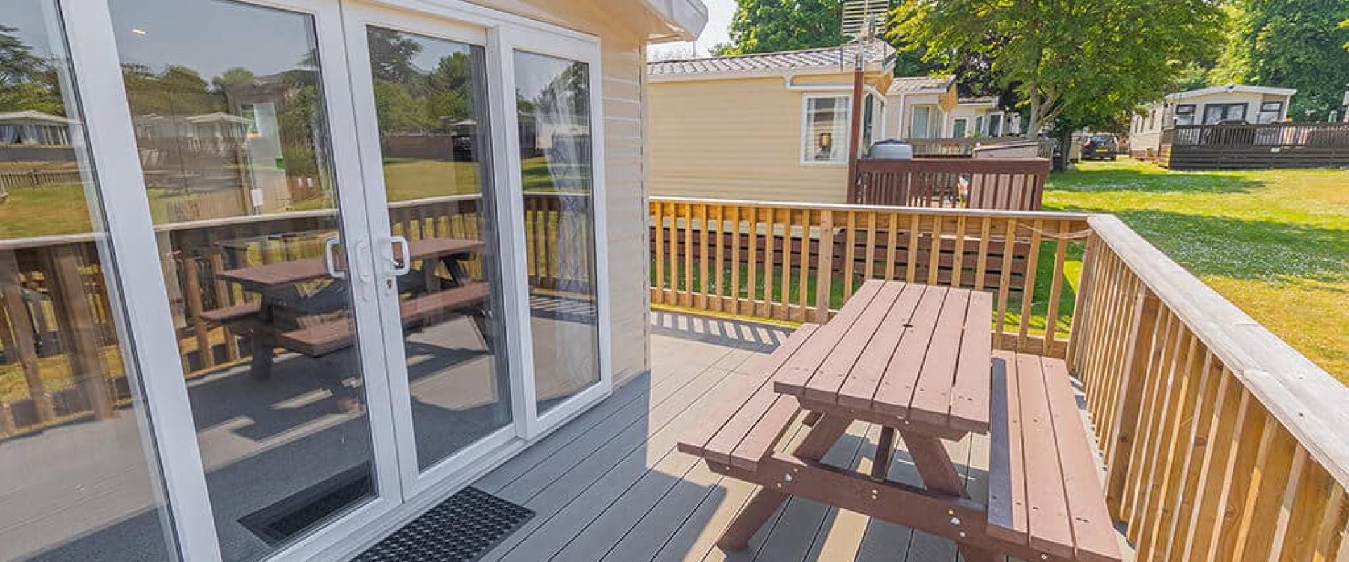 Oakcliff's Wren Plus Caravan private, outdoor decking, including a picnic bench.