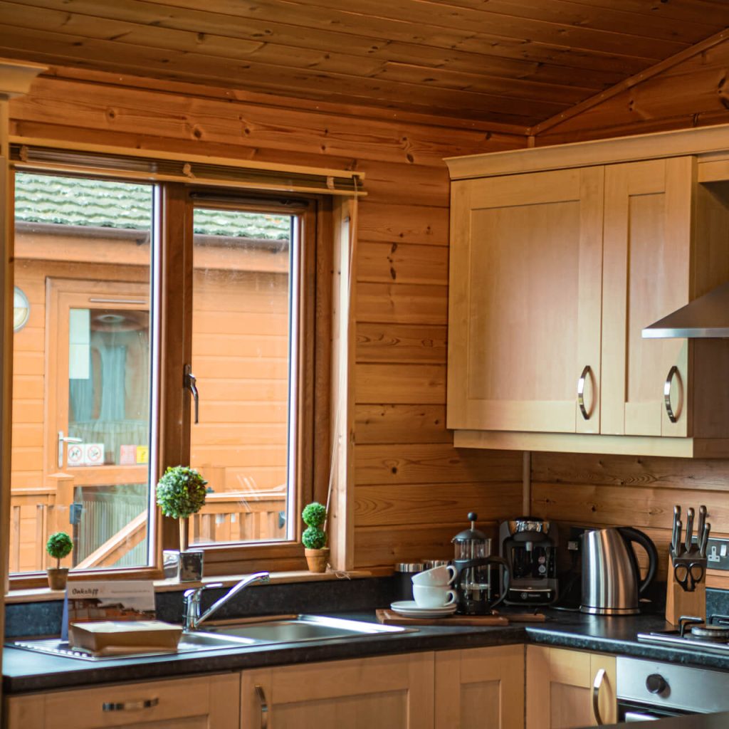 Oakcliff's Pine Lodge kitchen with a large window letting in natural light.