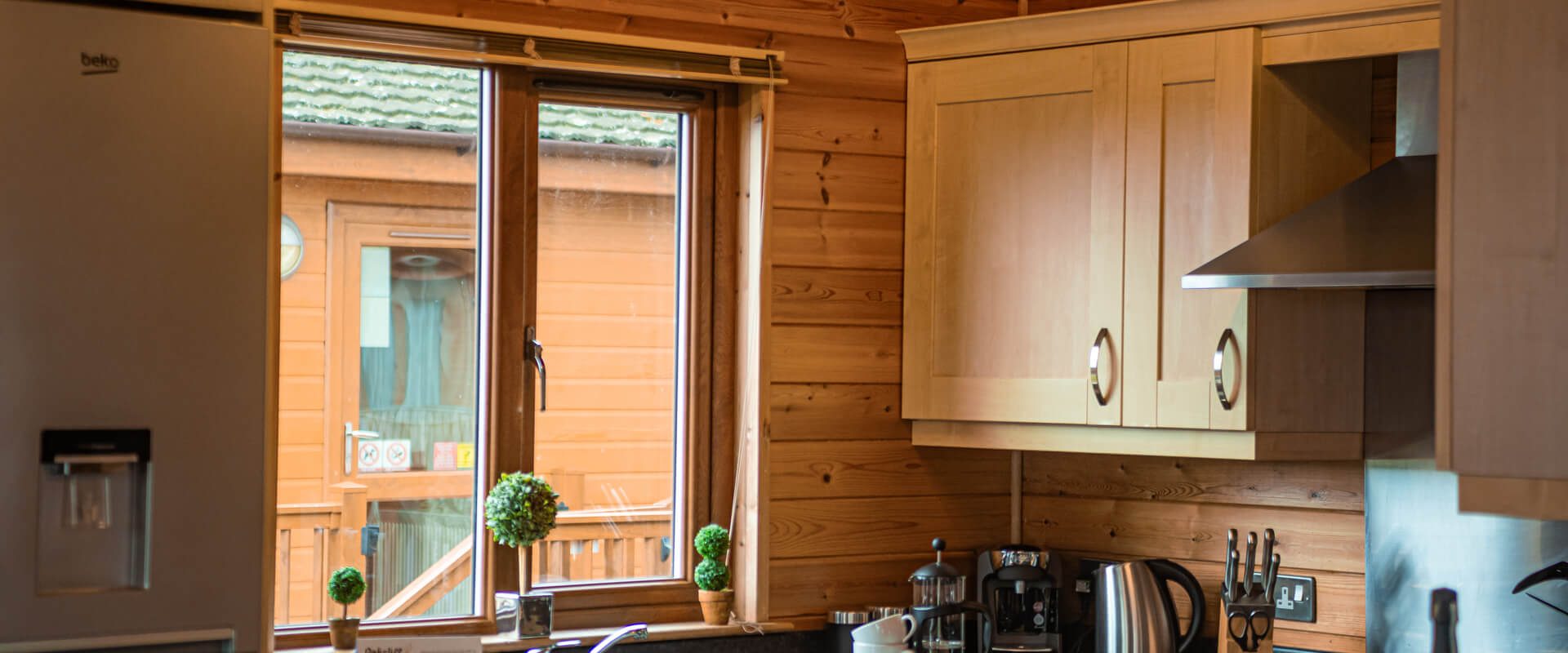 Oakcliff's Pine Lodge kitchen with a large window letting in natural light.