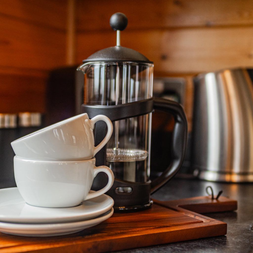 Two mugs stacked on top of each other with a cafetiere