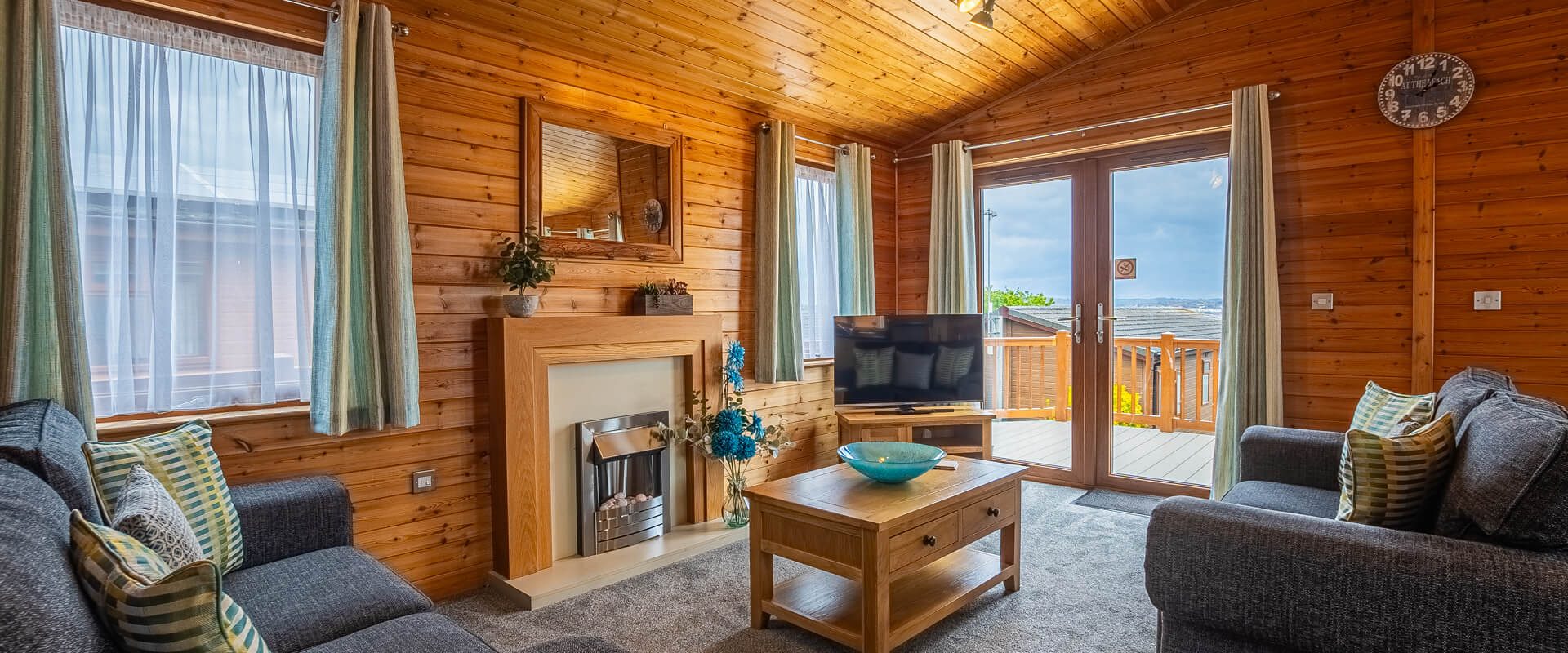 Oakcliff's Pine Lodge living room. Including beautiful wooden walls and furniture